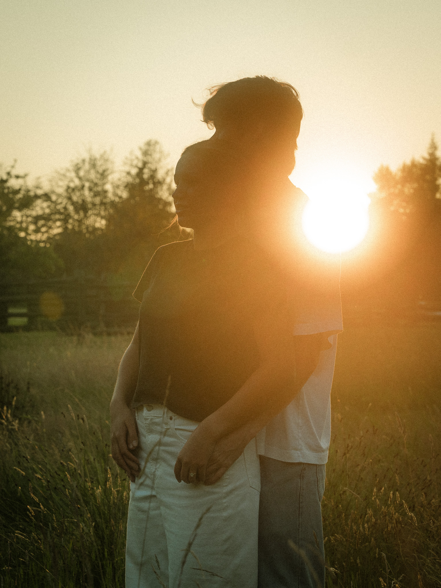 A couple enjoying a cinematic portrait session at Lighthouse Park in West Vancouver during golden hour.